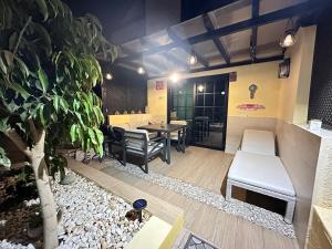a restaurant with a bench and a table and chairs at AGPI Fuerteventura Apartments in Costa Calma