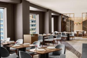 a restaurant with tables and chairs and windows at ANA InterContinental Tokyo by IHG in Tokyo