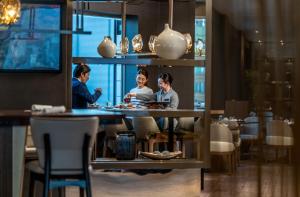 a group of people sitting at a table in a restaurant at ANA InterContinental Tokyo by IHG in Tokyo