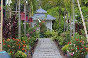 a garden path with flowers and a gazebo at Villa Beau Rivage in Bachok +112 photos