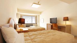Postel nebo postele na pokoji v ubytování Atami New Fujiya Hotel