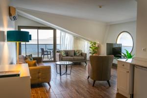 a kitchen and living room with a view of the ocean at Aurasia Beach Hotel in Marmaris