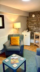 a living room with a couch and a table at Kings Arms Hotel in Kirkby Lonsdale