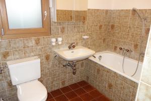 a bathroom with a toilet and a sink and a tub at Melezes K 010 - SKI & NATURE apartment 6 pers in Veysonnaz +8 photos