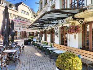 a row of tables and chairs outside of a restaurant at Le Duché de Godefroy in Bouillon