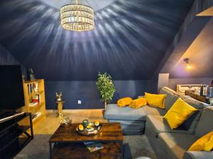 a living room with a couch and a table at Le Duché de Godefroy in Bouillon