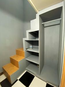 a walk in closet with stairs in a room at Helloroom Mampang Jl Bank in Jakarta