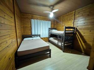 a bedroom with two bunk beds and a ceiling fan at Chácara cantinho na roça, Domingos Martins - Espirito Santo in Domingos Martins +40 photos