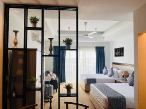 a hotel room with two beds and a room at Negombo Ocean Breeze Luxury Studio by Serendib Vacation in Negombo