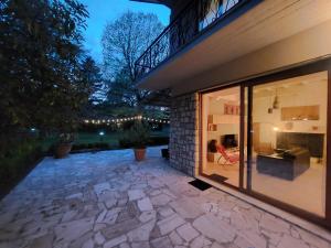 a house with large windows and a stone patio at Villa Bagno Santo in Sarteano