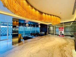 a lobby with a gold chandelier and a dance floor at Luxury Studio Bayz By Danube Business Bay Marasi Drive Dubai in Dubai