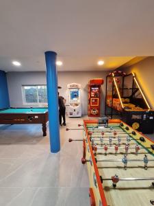 a room with a pool table and a blue pole at mobil home in Villeneuve-lès-Maguelonne