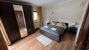 a bedroom with a bed and a door to a hallway at Adlerek Krynica in Krynica Morska