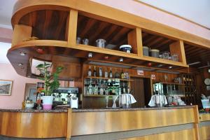 a bar in a restaurant with a shelf above it at Hotel Bellavista Meublè in Monte Isola