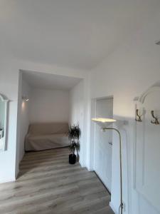 a white room with a bed and a lamp at Riviera 990 Chalet in (( Ogradena Nouă ))
