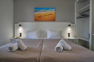 a bedroom with a large bed with two pillows at Fiona Apartments Roda Corfu in Roda