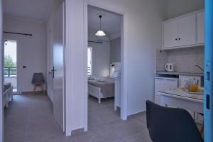 a room with a kitchen and a living room at Fiona Apartments Roda Corfu in Roda +59 photos