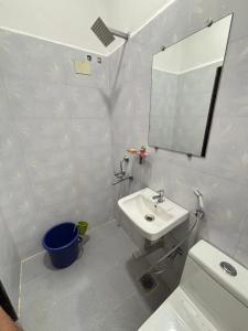 a bathroom with a sink and a toilet and a mirror at Studio Serinity Cove R-2 by Mukund Sadan Arambol in Arambol
