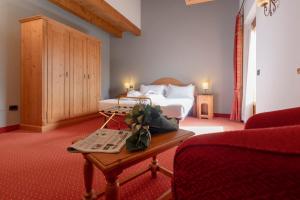 Postel nebo postele na pokoji v ubytování Gaarten Hotel Benessere Spa by Kleos Group Collection