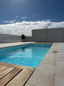 a swimming pool on top of a building at BeachVibe in Puerto Naos