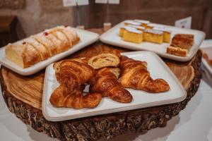 three plates of croissants and other pastries on a table at Pazo Arretén in Padrón +54 photos