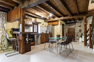 a kitchen with a table and chairs in a room at Casa Rural Adrimar in Selorio