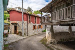 an old building with a bridge over a street at Casa Rural Adrimar in Selorio