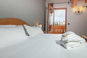 Postel nebo postele na pokoji v ubytování Gaarten Hotel Benessere Spa by Kleos Group Collection