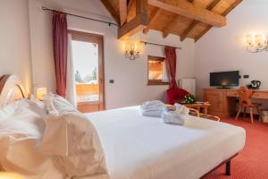 Postel nebo postele na pokoji v ubytování Gaarten Hotel Benessere Spa by Kleos Group Collection