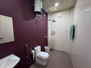 a bathroom with a white toilet and a sink at Elk Seizon Retreat in Kundakal