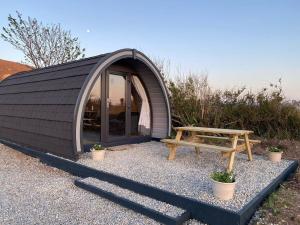 a dome tent with a bench and a picnic table at Dingle Wild - Luxury Pod in Dingle