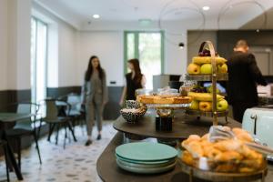 a group of people walking in a room with food at Luna Residence in Timişoara
