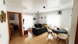 a living room with a couch and a table at Low Price Modern Apartment Aircon & Filter Water in San Pedro del Pinatar