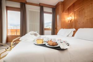 Postel nebo postele na pokoji v ubytování Gaarten Hotel Benessere Spa by Kleos Group Collection