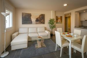 a living room with a couch and a table at Las Catedrales in Foz
