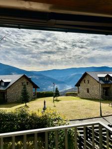 a view from the porch of a house with mountains in the background at El Mirador d'Olp in Olp