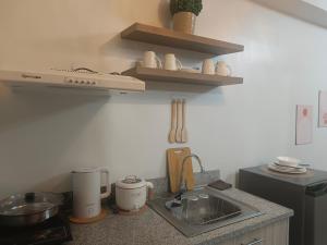 a kitchen with a sink and a counter top at Mesavirre Garden Residences Condo Bacolod in Bacolod