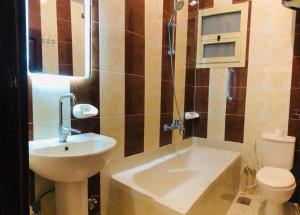 a small bathroom with a sink and a toilet at joy house in Luxor +32 photos