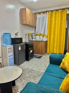 a living room with a couch and a table at Koki Bnbs Kamakis in Ruiru +12 photos