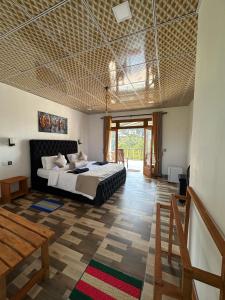 a bedroom with a large bed and a large window at Royal Vantage in Ella