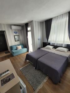 Postel nebo postele na pokoji v ubytování Guest House Taligarov