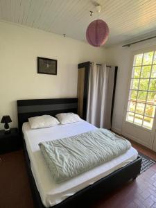 a bedroom with a large bed in a room at La Colline aux Chalets, Jaccuzi, Sauna in Saint-Chamarand