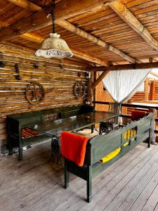 a dining room with a table and chairs in a cabin at Casa de vacanță Trei Zâne in Sovata