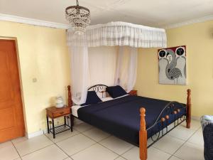 Rúm í herbergi á Villa Manamé, face à l'océan