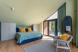 a bedroom with a bed and a large window at MÁK Kismaros in Kismaros