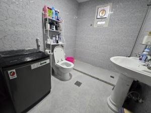 a bathroom with a toilet and a sink at Luxury Home Studio in Abu Dhabi