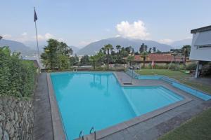 a large swimming pool with mountains in the background at Res Roncaccio, Cancro by HolAp SA in Vairano
