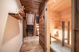 a sauna with wooden walls and wooden flooring at Chalet Jolimont Châtel - by EMERALD STAY in Châtel