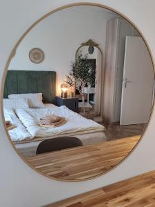 a bedroom with a large mirror on the wall at Dream Oasis in Banja Luka
