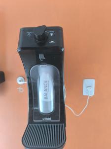 a black appliance sitting on a table next to an outlet at Apartamento mobiliado Praia do Farol in Belém +18 photos